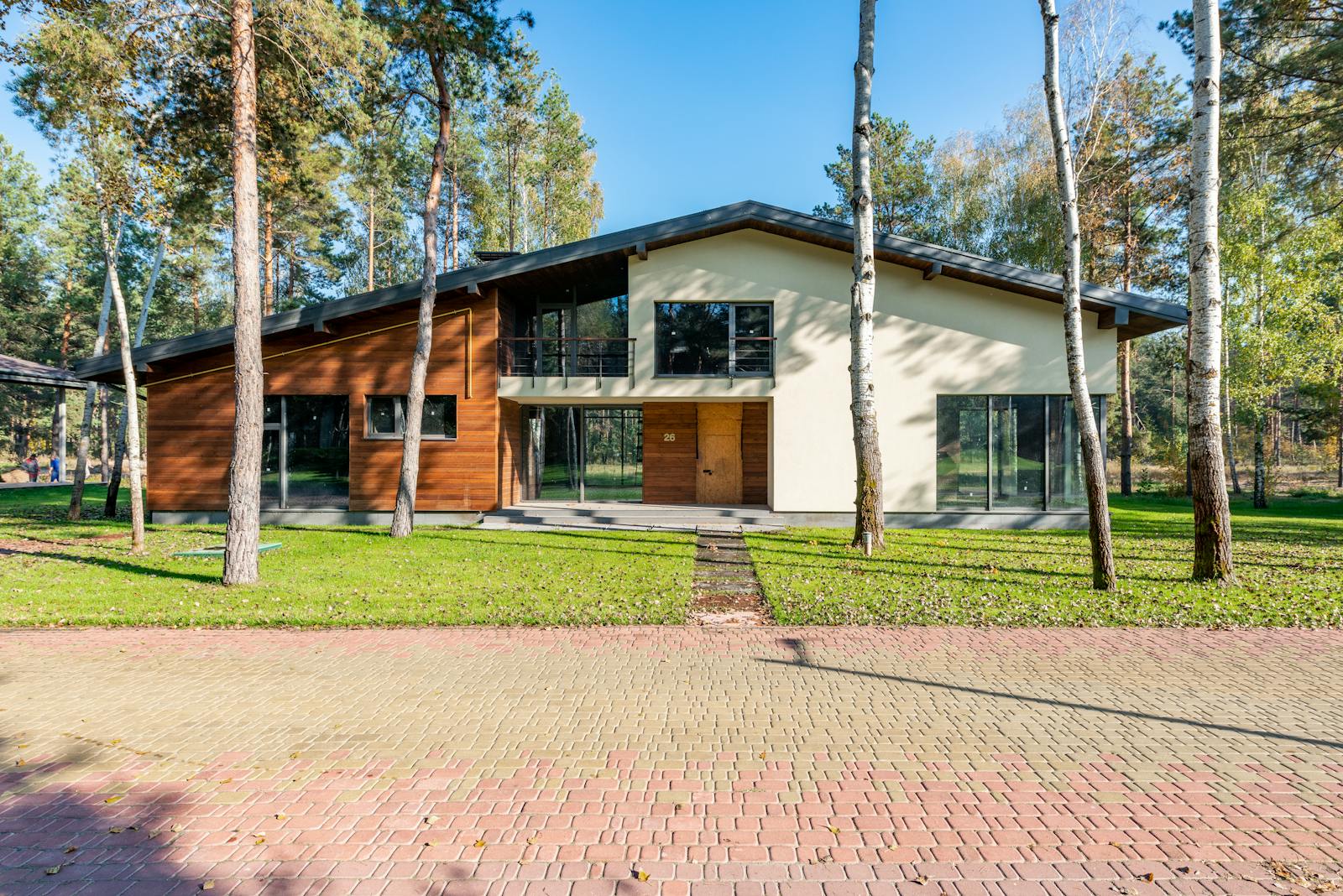 Modern home exterior with wood siding and landscaped grounds