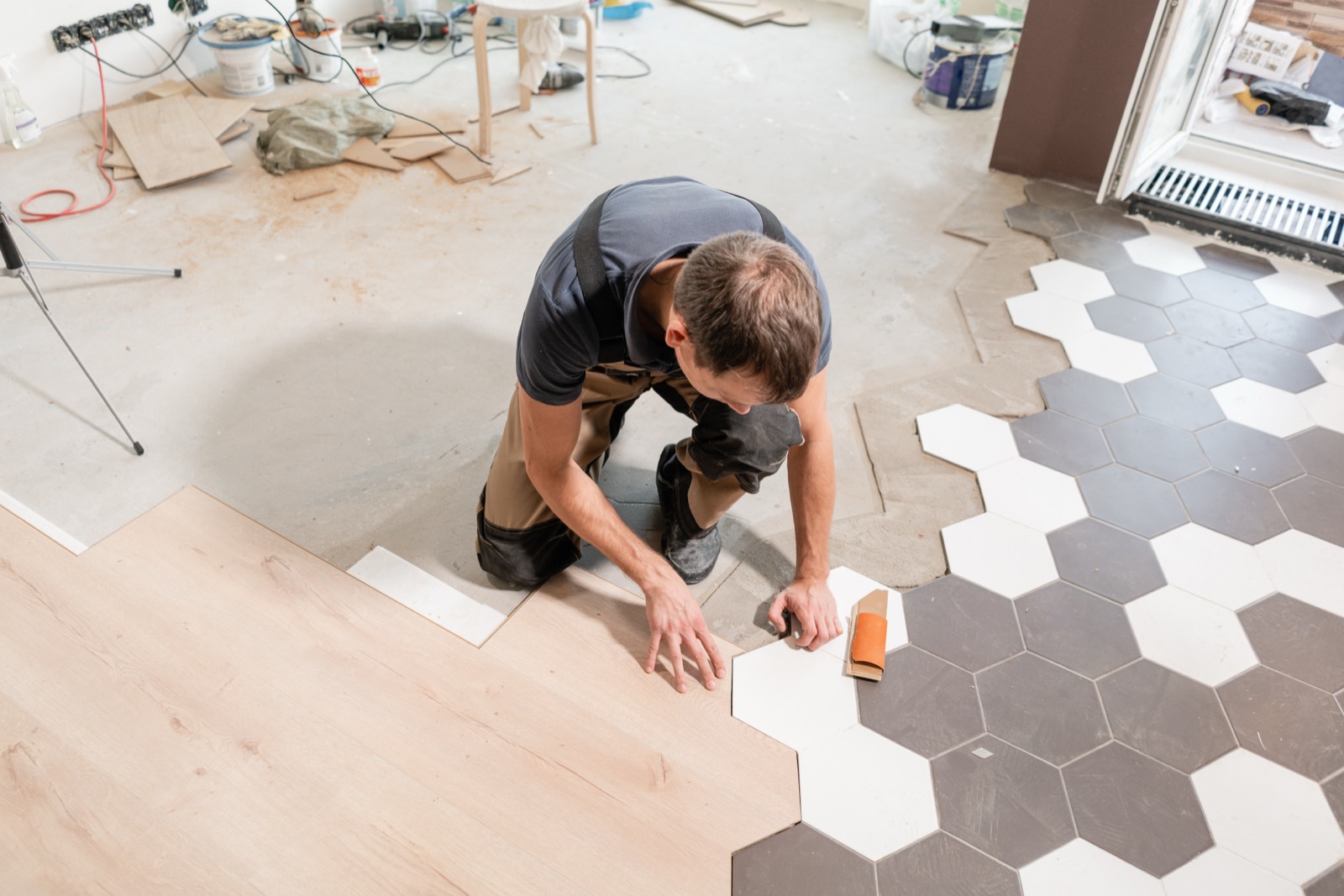 Kitchen renovation with precision wood and honeycomb tile transition by Yoline Construction